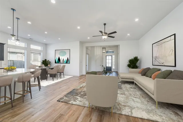 a living room with furniture and wooden floor