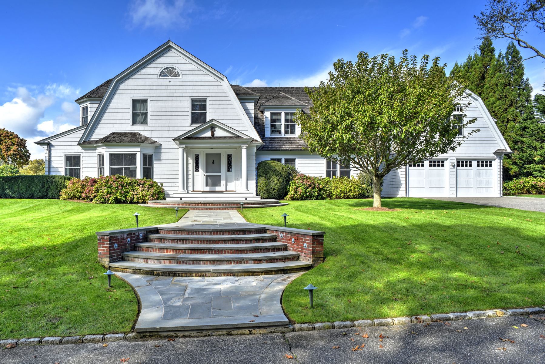 369 Town Lane Amagansett, NY 11930 - Photo 2 of 17 a front view of a house with a yard