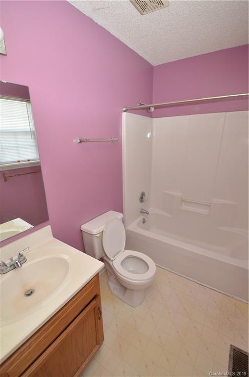 5601 Sunpath Circle Charlotte, NC 28269 - Photo 11 of 15 a bathroom with a sink a toilet and shower