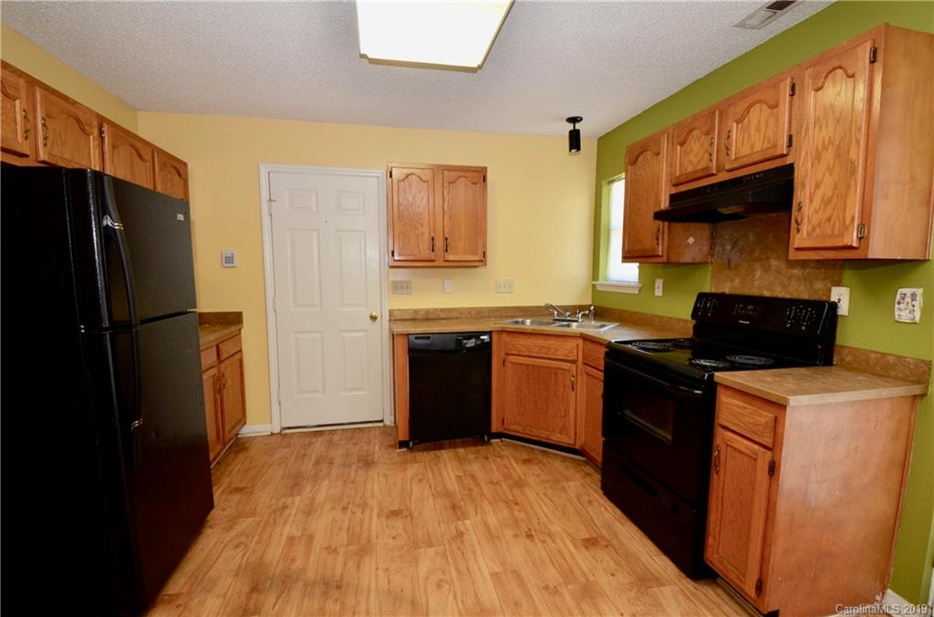 5601 Sunpath Circle Charlotte, NC 28269 - Photo 4 of 15 a kitchen with stainless steel appliances granite countertop a refrigerator stove top oven a sink and dishwasher
