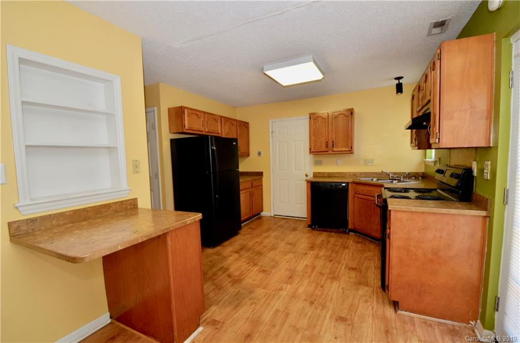 5601 Sunpath Circle Charlotte, NC 28269 - Photo 5 of 15 a kitchen with stainless steel appliances granite countertop a refrigerator and a stove top oven