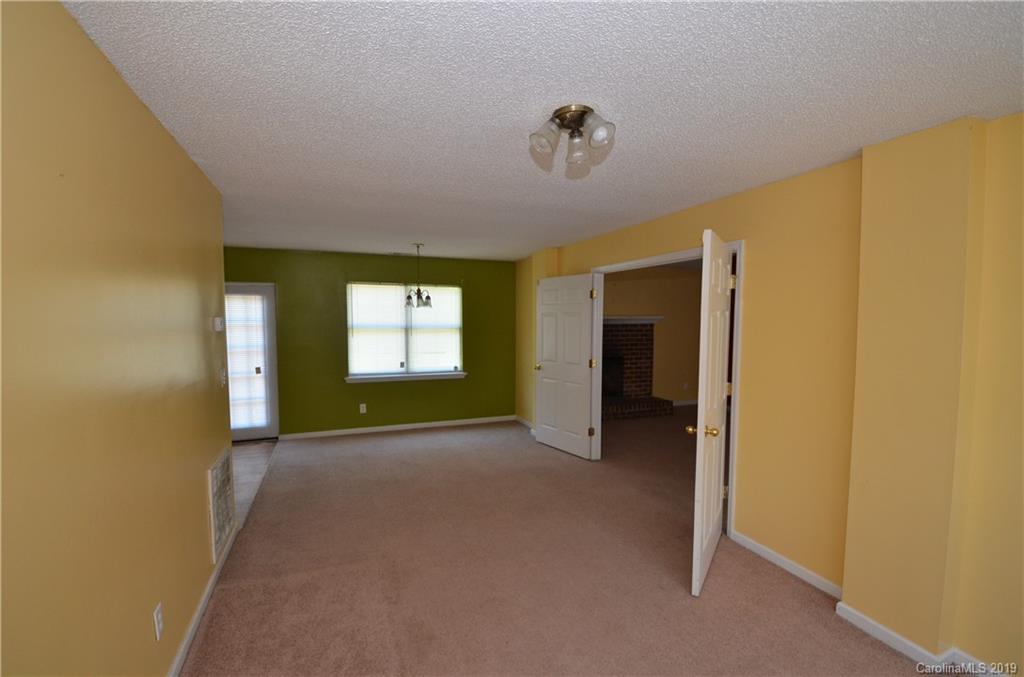 5601 Sunpath Circle Charlotte, NC 28269 - Photo 9 of 15 a view of an empty room with a fireplace and a window