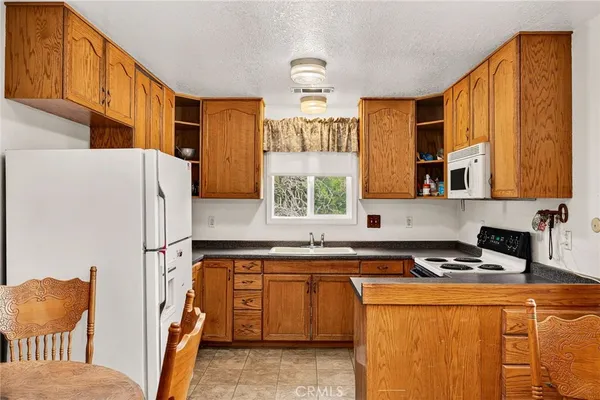 a kitchen with a refrigerator and a sink