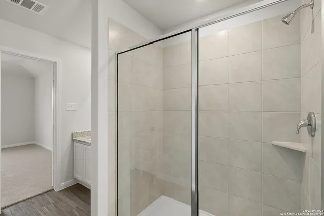 a bathroom with a granite countertop sink and a vanity