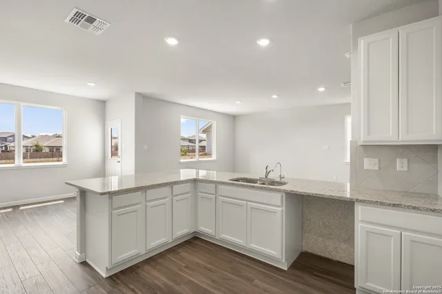 a kitchen with a sink stove and cabinets