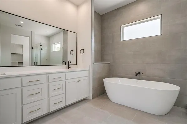 a bathroom with a bathtub and a sink