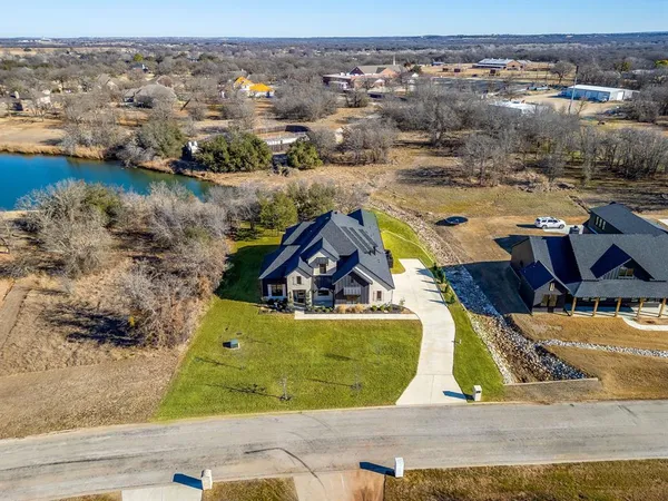an aerial view of a house with a lake view