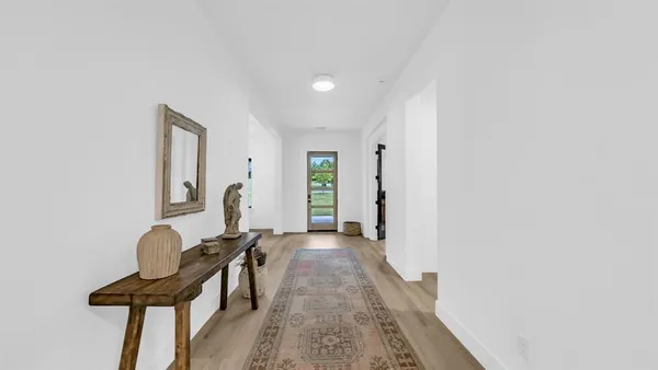 a view of a livingroom with furniture and a window