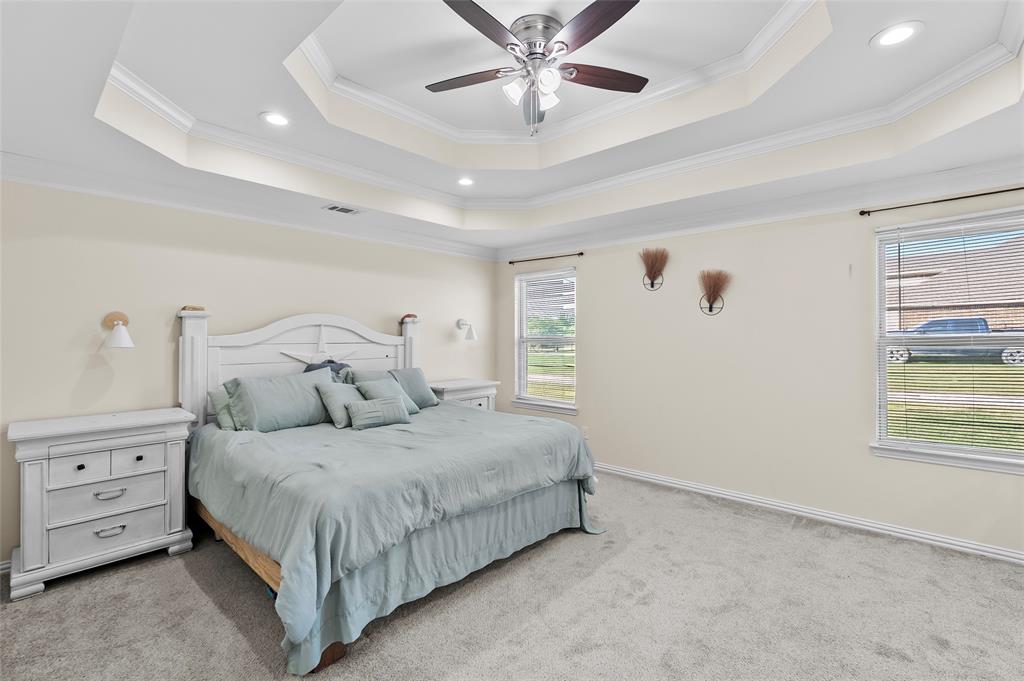 8002 County Road 1058 Rice, TX 75155 - Photo 10 of 19 a bedroom with a bed and a chandelier