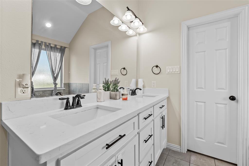 8002 County Road 1058 Rice, TX 75155 - Photo 11 of 19 a bathroom with double vanity and a mirror