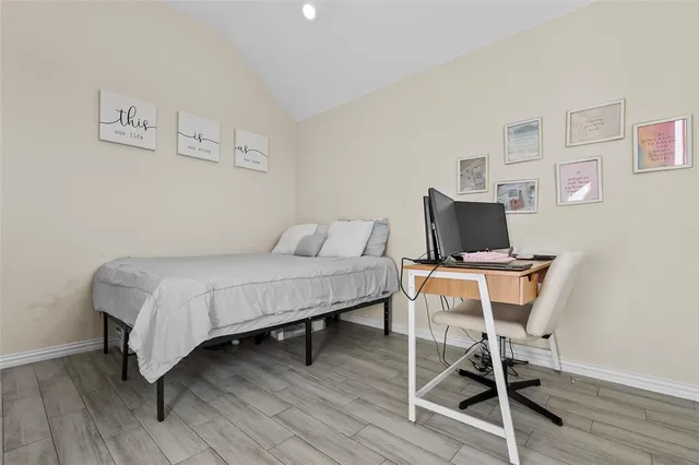 a bedroom with a bed a window and a television