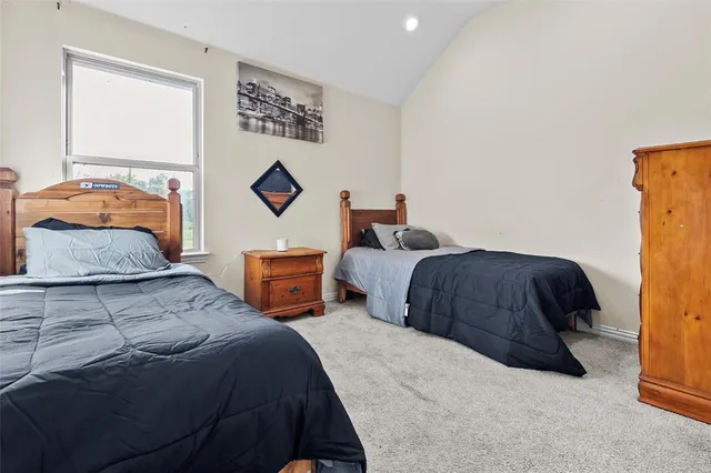 a bedroom with a bed and a chair