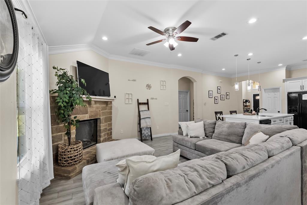 8002 County Road 1058 Rice, TX 75155 - Photo 5 of 19 a living room with furniture a fireplace and a flat screen tv