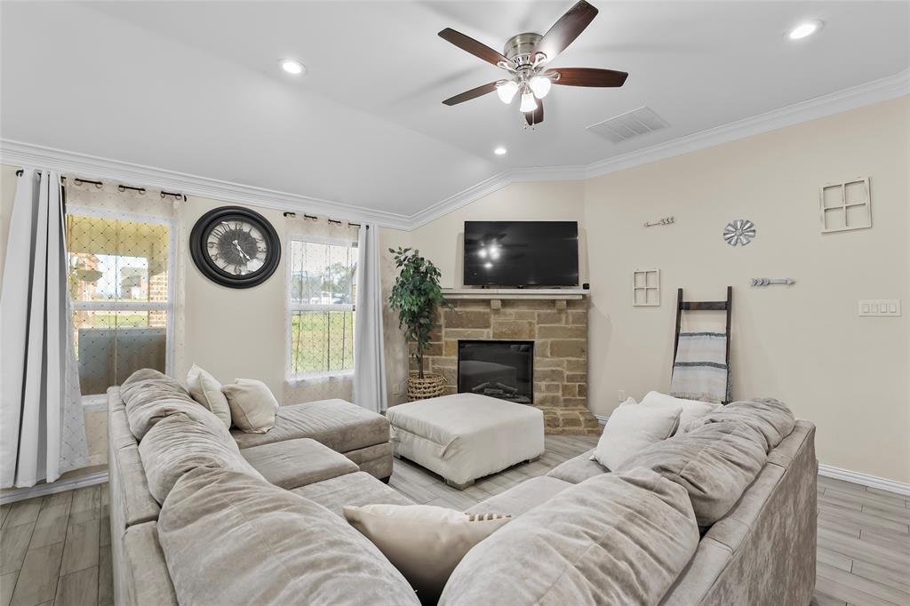 8002 County Road 1058 Rice, TX 75155 - Photo 7 of 19 a living room with furniture a fireplace and a flat screen tv