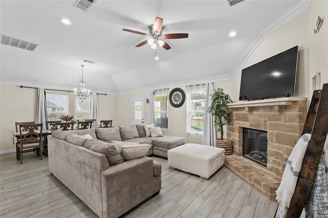 a living room with furniture a fireplace and a flat screen tv