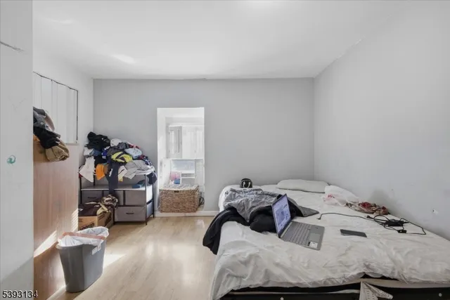 a bedroom with a bed and a wooden floor