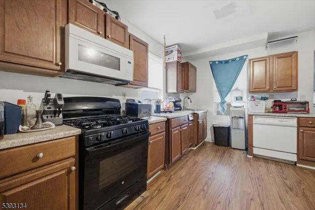 a kitchen with a stove a sink and a microwave