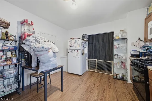 a kitchen with furniture and wooden floor