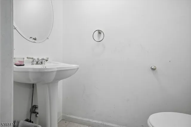 a bathroom with a sink toilet and a mirror
