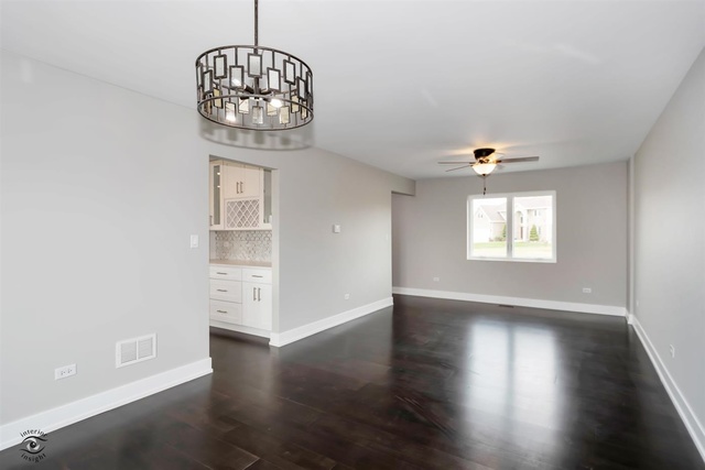 4997 Ribbon Drive Monee, IL 60449 - Photo 8 of 28 an empty room with wooden floor and windows