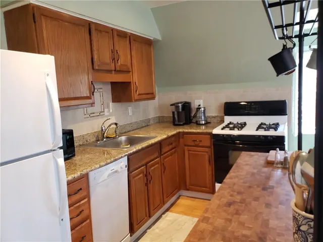a kitchen with a sink a stove and refrigerator
