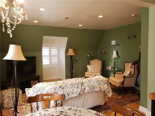 a bedroom with a bed and a chandelier