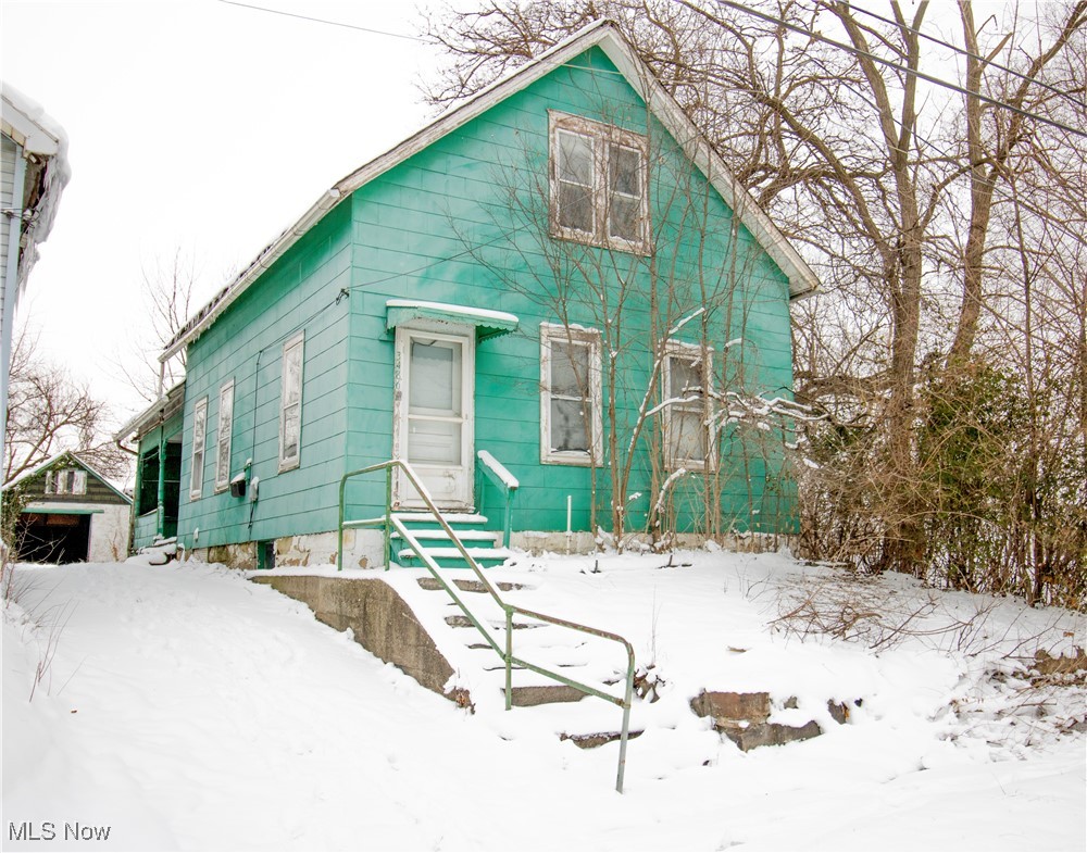 3486 Kimmel Road Cleveland, OH 44105 - Photo 1 of 12 Snow covered rear of property with an outdoor structure