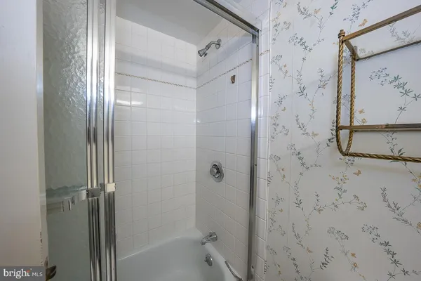 a bathroom with a bathtub and shower