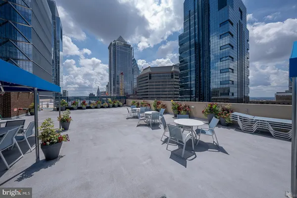 a view of a patio with dining table and chairs with plants