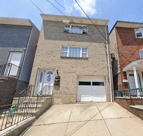 a view of a brick house with many windows
