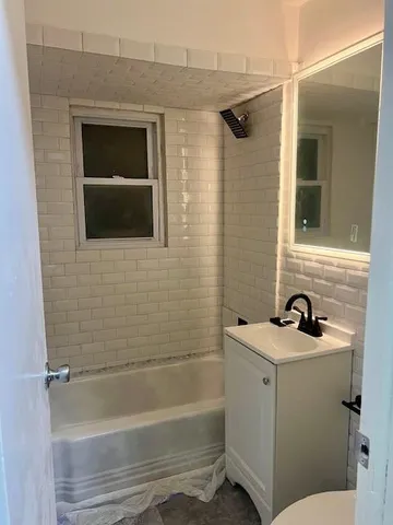 a bathroom with a shower and a sink