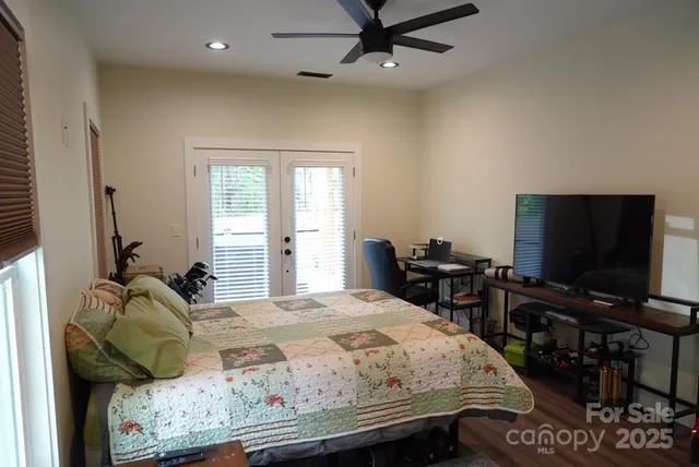 a bedroom with a bed and a flat screen tv