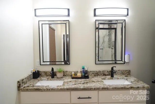 a bathroom with vanity granite a granite countertop mirror and sink