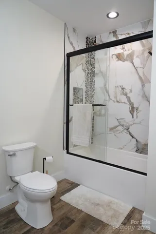 a bathroom with a toilet and a shower