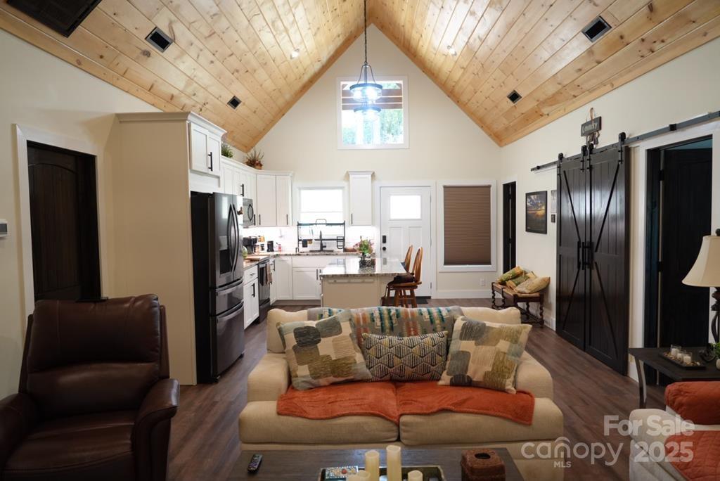 79 Abbey View Road Bryson City, NC 28713 - Photo 5 of 21 a living room with furniture windows and a chandelier