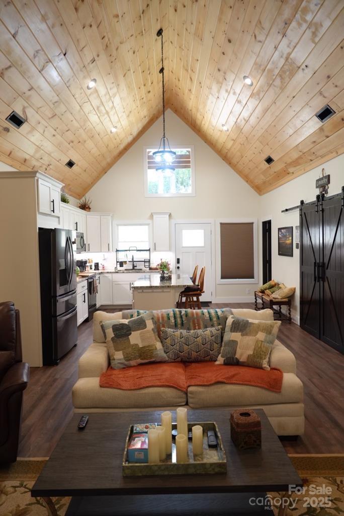 79 Abbey View Road Bryson City, NC 28713 - Photo 6 of 21 a living room with furniture a chandelier and a flat screen tv