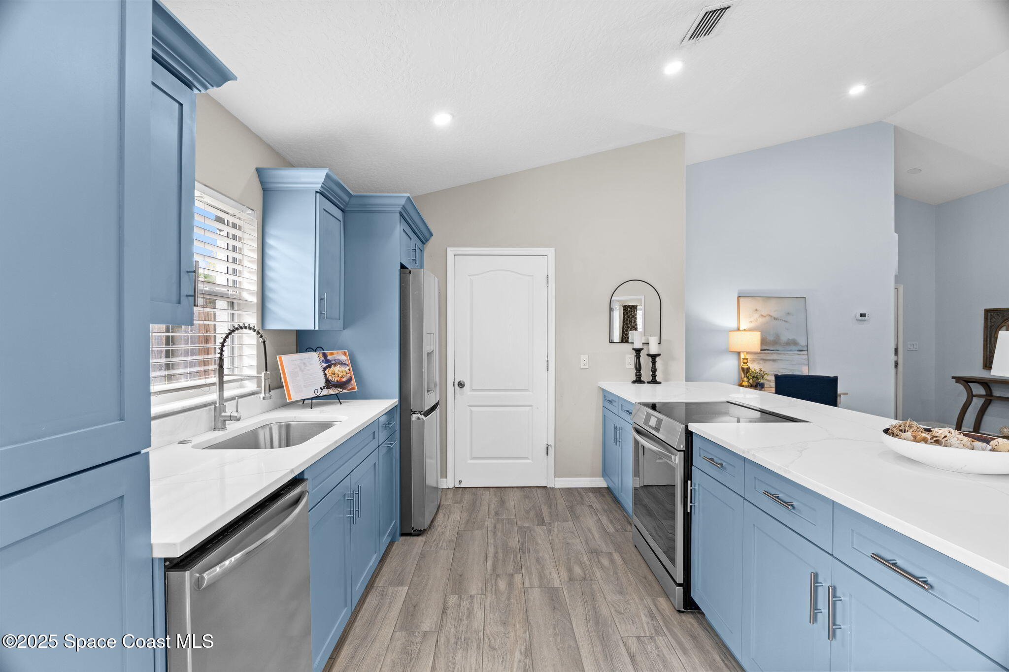 4664 Grand Meadows Boulevard Melbourne, FL 32934 - Photo 11 of 32 a kitchen with a sink stove top oven and refrigerator