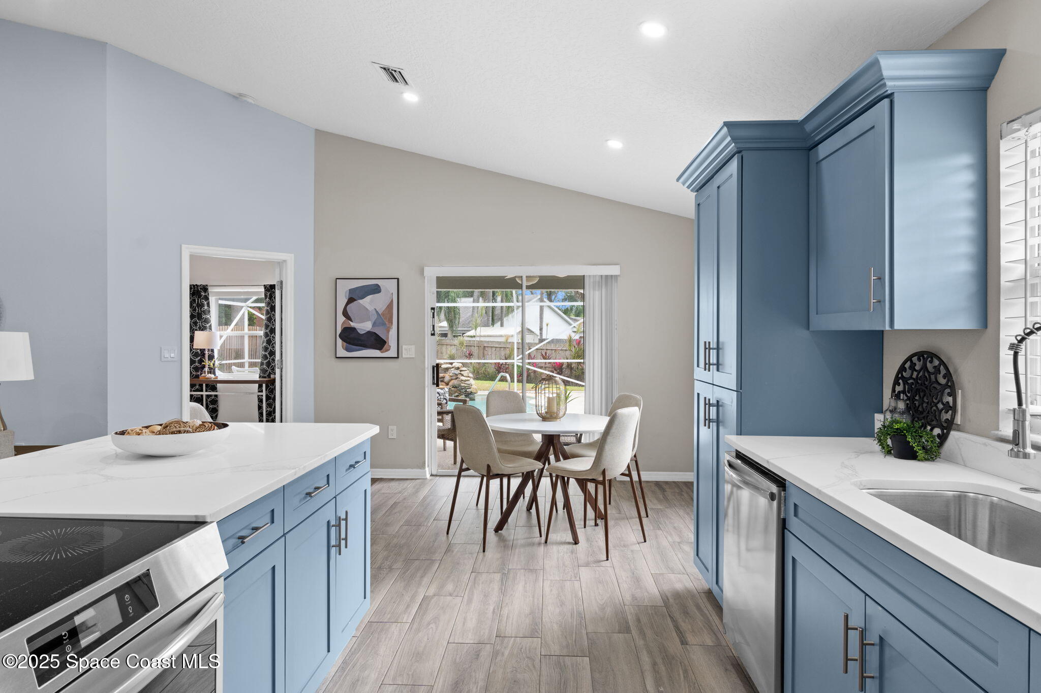 4664 Grand Meadows Boulevard Melbourne, FL 32934 - Photo 13 of 32 a kitchen with a table chairs sink and cabinets