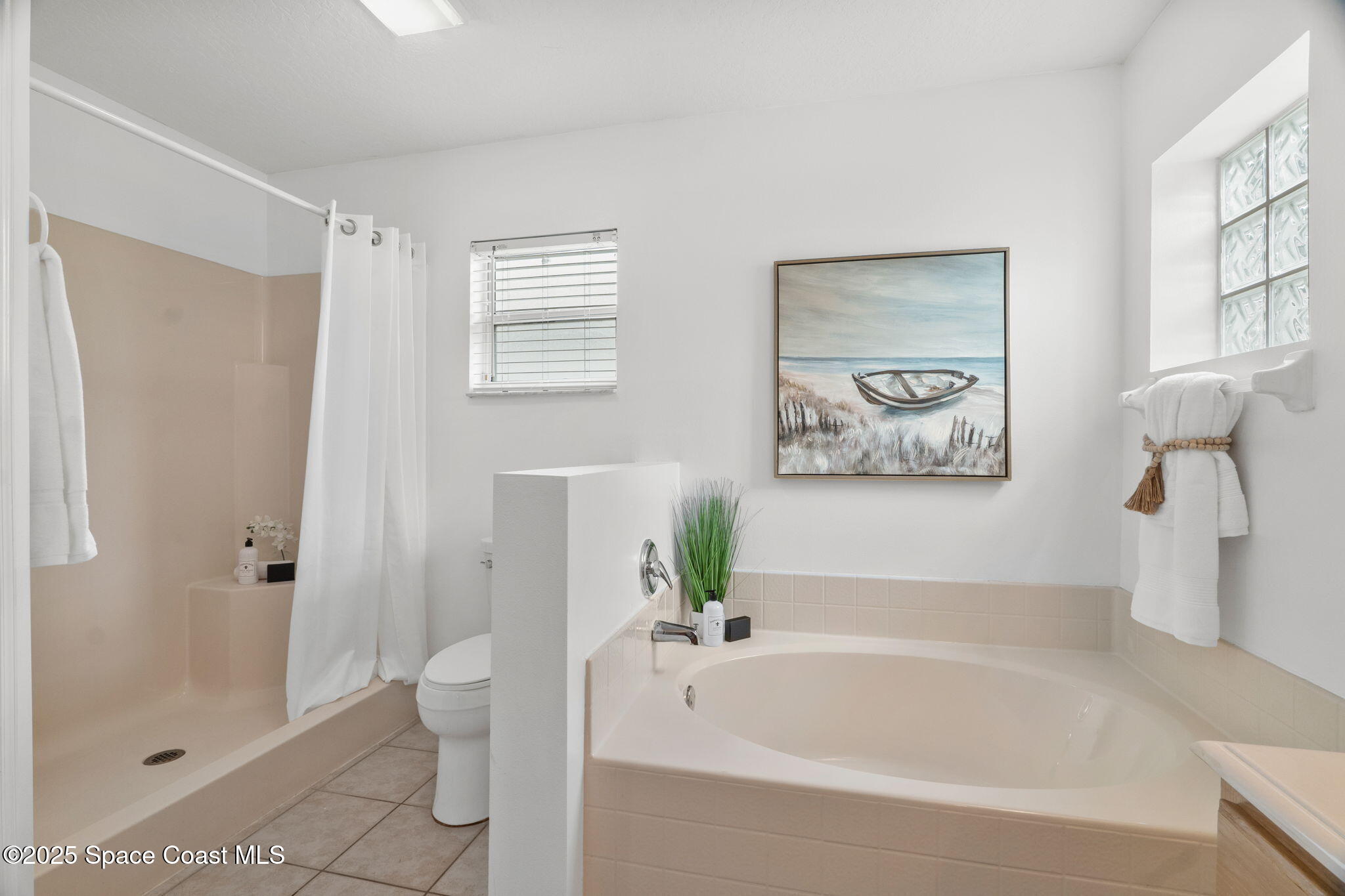 4664 Grand Meadows Boulevard Melbourne, FL 32934 - Photo 16 of 32 a bathroom with a bathtub and a shower