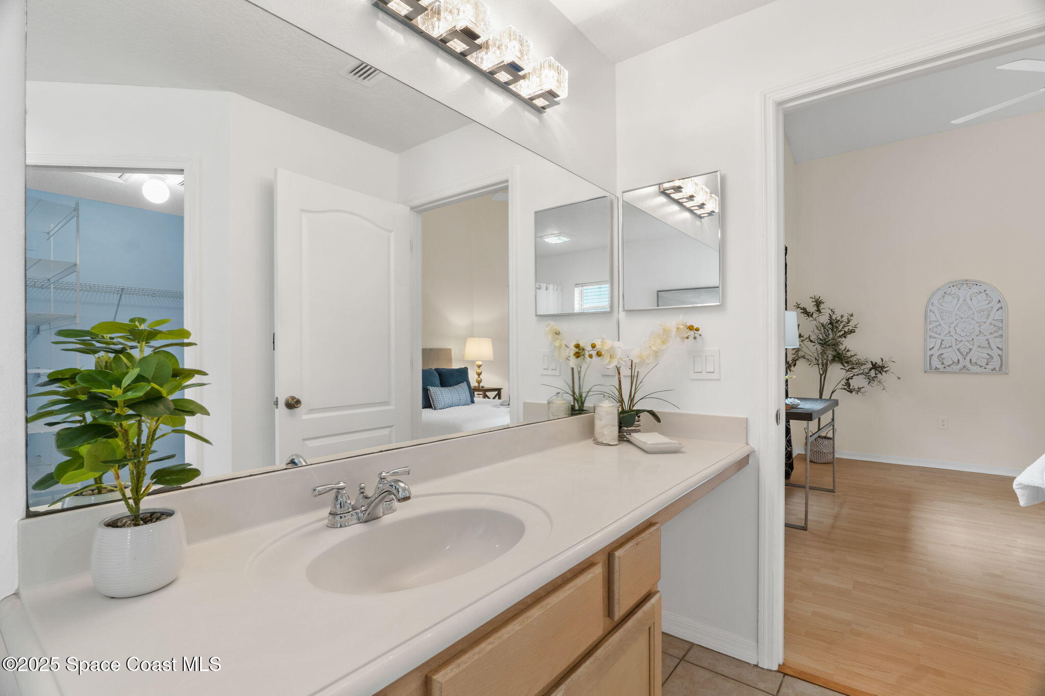 4664 Grand Meadows Boulevard Melbourne, FL 32934 - Photo 18 of 32 a bathroom with a sink and a mirror