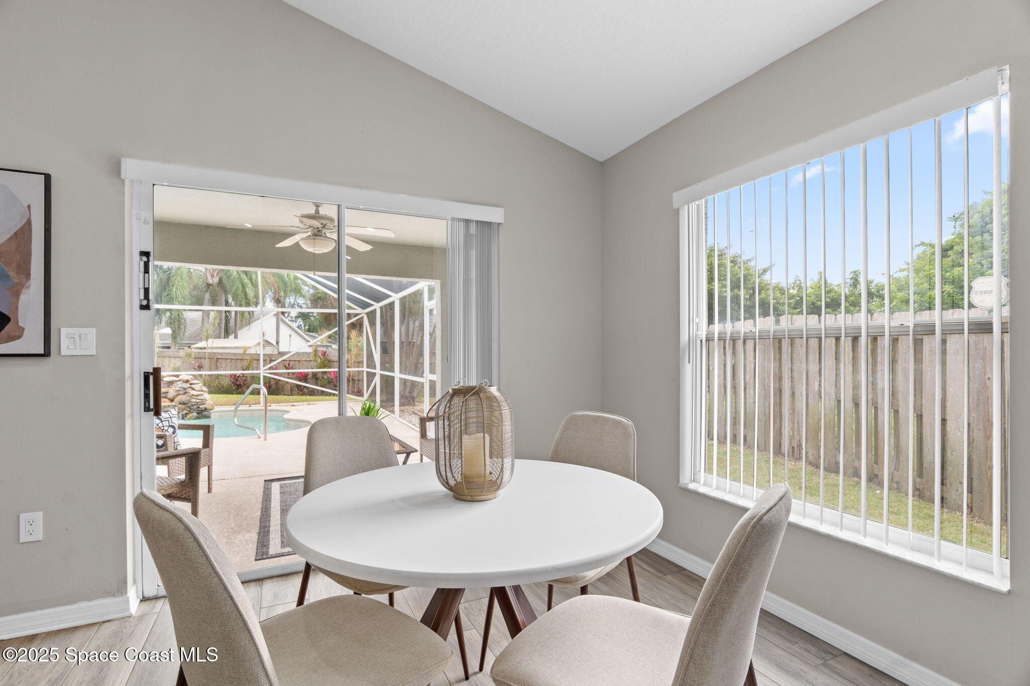 4664 Grand Meadows Boulevard Melbourne, FL 32934 - Photo 20 of 32 a view of a dining room with furniture window and wooden floor