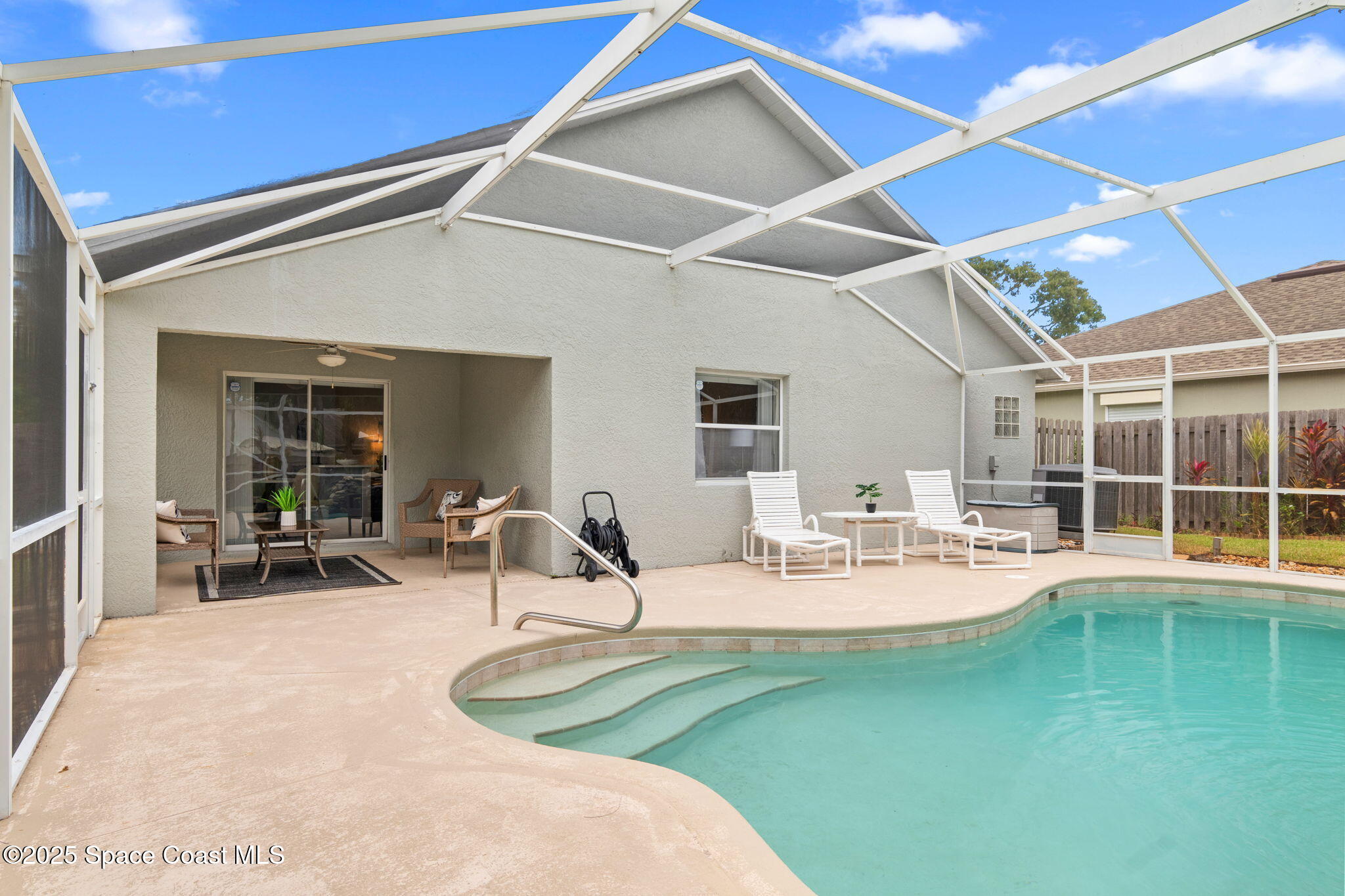 4664 Grand Meadows Boulevard Melbourne, FL 32934 - Photo 22 of 32 a house view with swimming pool and sitting space
