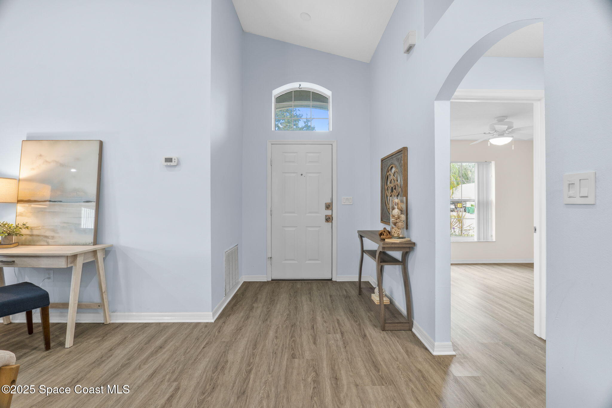 4664 Grand Meadows Boulevard Melbourne, FL 32934 - Photo 3 of 32 wooden floor and table in a room