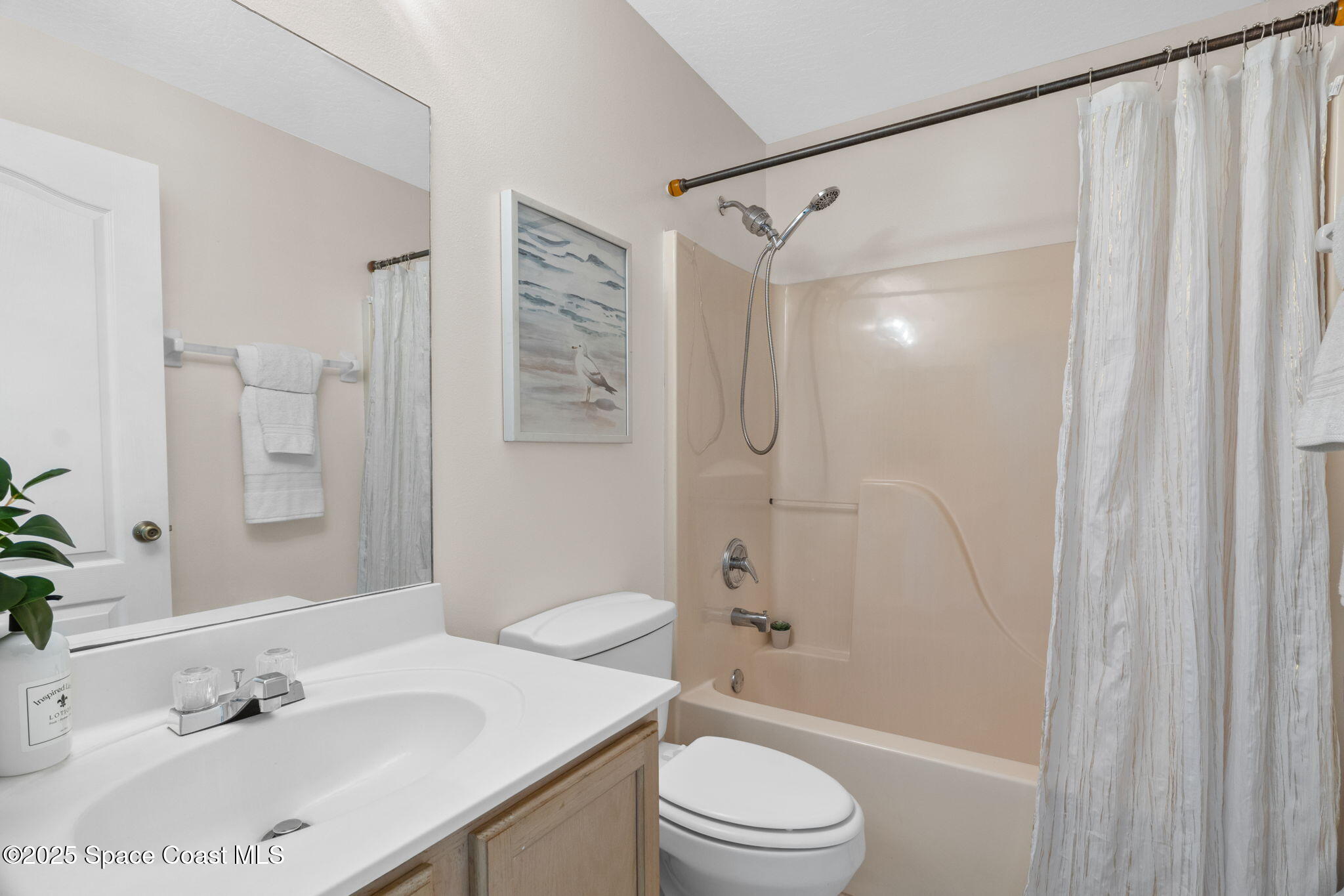 4664 Grand Meadows Boulevard Melbourne, FL 32934 - Photo 5 of 32 a bathroom with a sink a toilet and shower