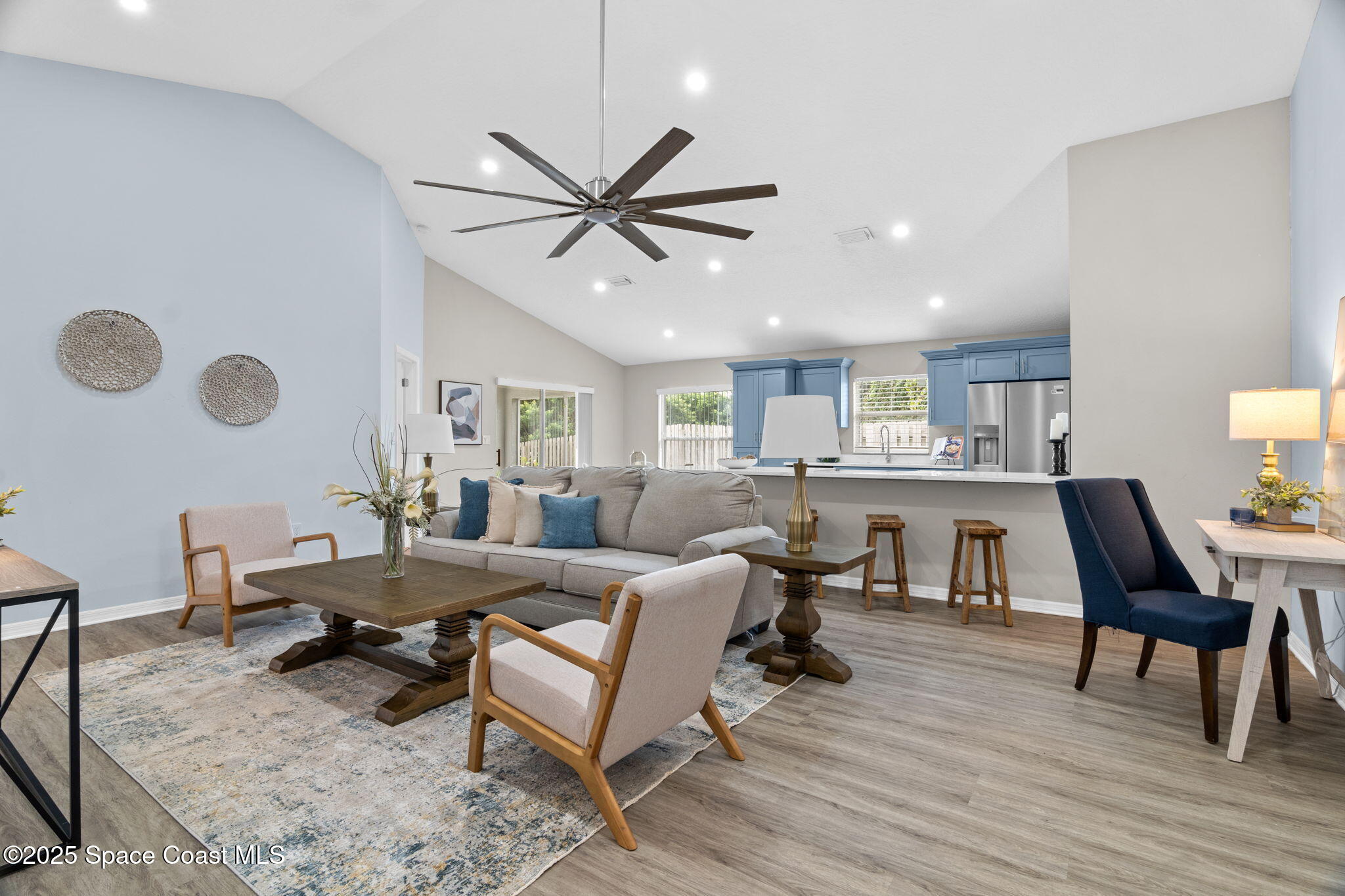 4664 Grand Meadows Boulevard Melbourne, FL 32934 - Photo 7 of 32 a living room with furniture and a wooden floor