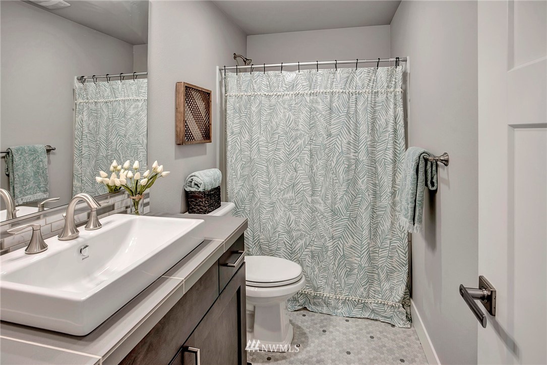 20403 South Danvers Road, Unit B Lynnwood, WA 98036 - Photo 24 of 29 a bathroom with a sink toilet and shower