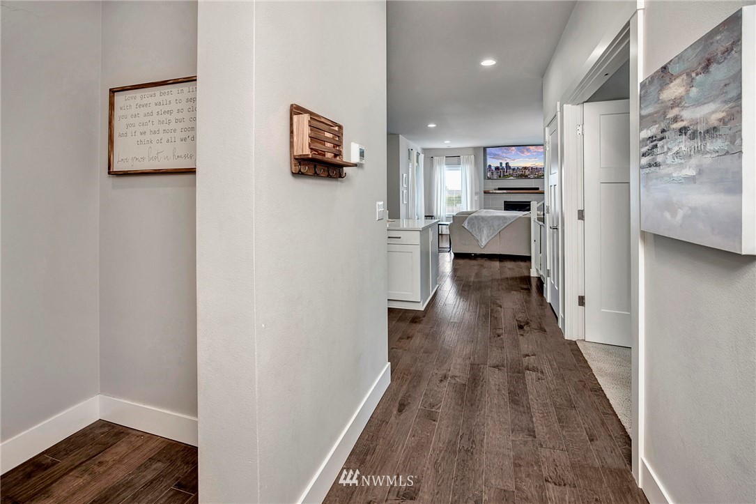 20403 South Danvers Road, Unit B Lynnwood, WA 98036 - Photo 5 of 29 a view of a hallway with wooden floor and furniture