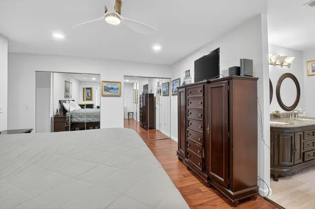 a large bedroom with bed and a flat tv screen