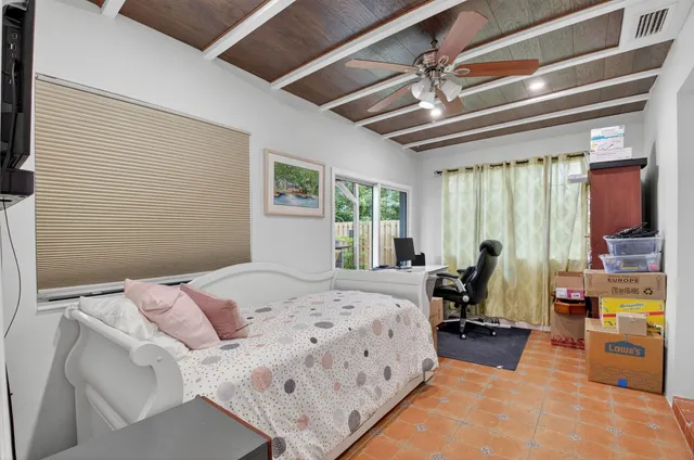 a bed room with a bed and a chandelier