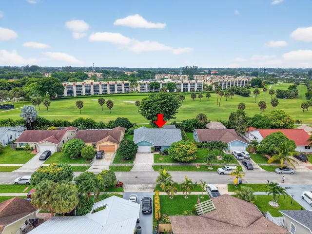 an aerial view of a houses with city view